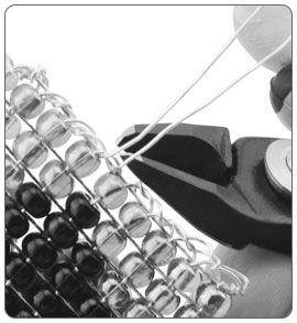 Plier cutters snipping excess wire